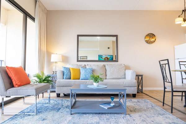 Bright living room with colorful cushions and modern seating.