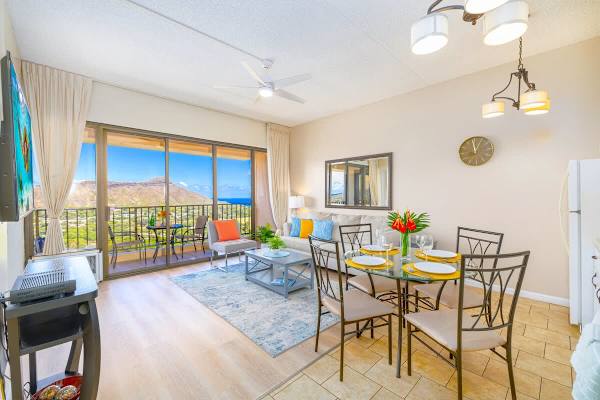 Bright living and dining area with mountain and ocean views from the balcony