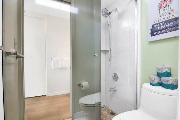 Compact bathroom with a tiled walk-in shower and modern fixtures.