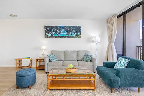 Bright living room with modern seating and natural light from large windows