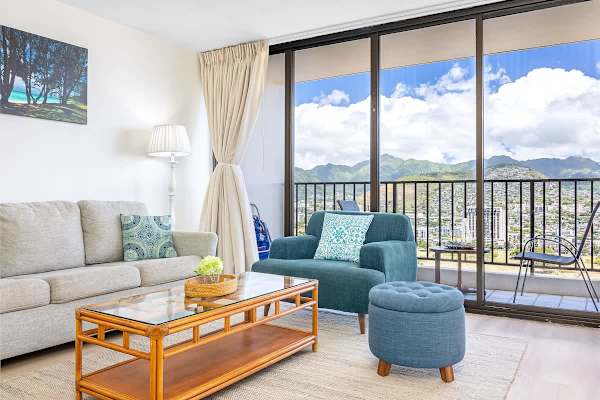 Bright living room with mountain views and a balcony seating area