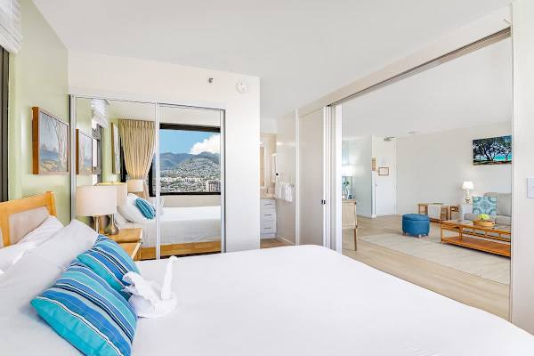 Bright bedroom with a mountain view and sliding doors to the living area