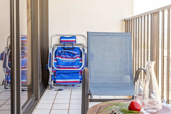 Relax on the balcony with seating and a view of the city skyline.