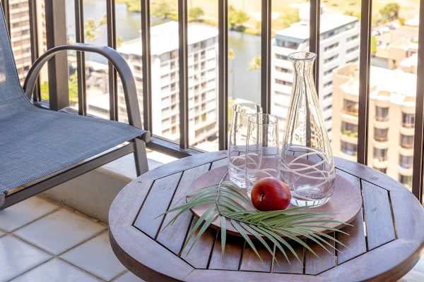 Relax on the balcony with city views and a cozy seating area.