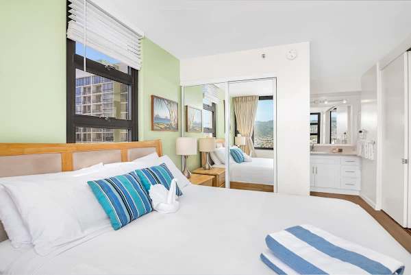 Bright bedroom with city views and modern decor for a relaxing stay.