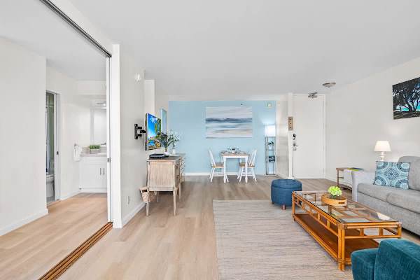 Bright living and dining area with coastal-inspired decor and natural light