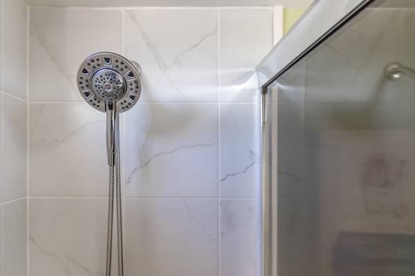 Modern showerhead with adjustable settings in a tiled bathroom