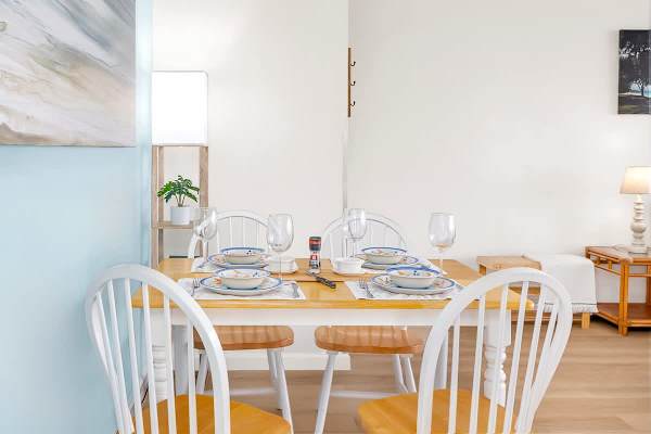 dining table set for four in a bright, modern space