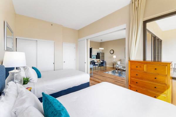 Bedroom with closet and one dresser and sliding door that separates the two ambiances 