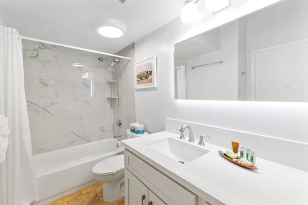 Full bathroom with tub and shower combo, and a vanity with cabinet.