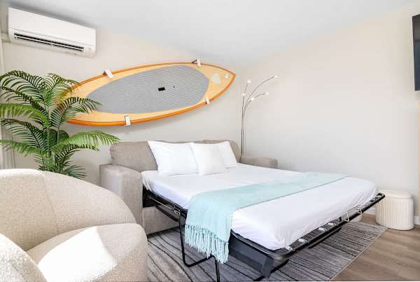 Sleeper sofa in the living area. The surfboard is display only.