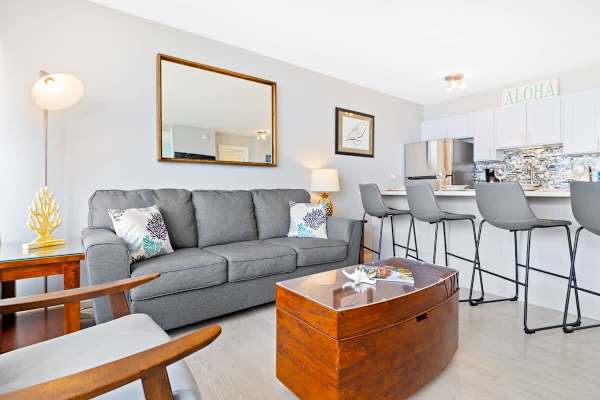 The living area has a pull-out sleeper sofa, chair, and a coffee table!