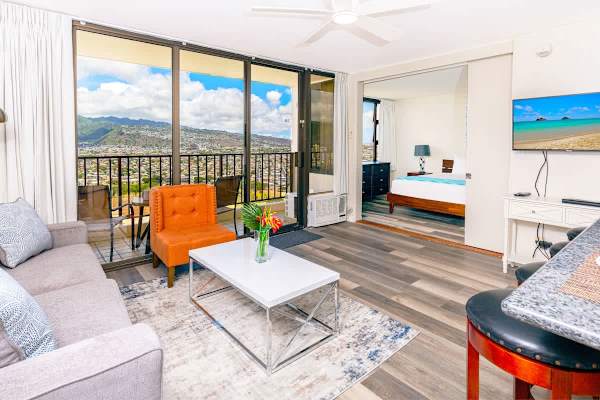 Living room with a pull out sofa, chair, 43" TV and mountain views