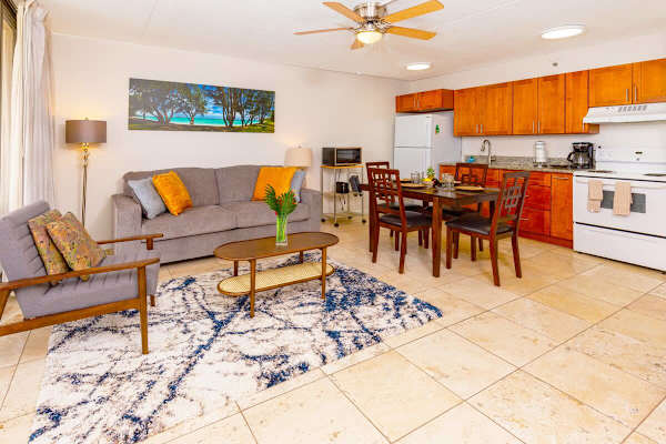 Open kitchen with a dining table and chairs for 4 people, pull-out sleeper sofa, chair, coffee table