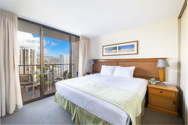 Bedroom with a king size bed and flat screen TV and access to the balcony
