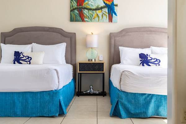 Enjoy a restful night's sleep in these two plush queen beds in the bedroom.