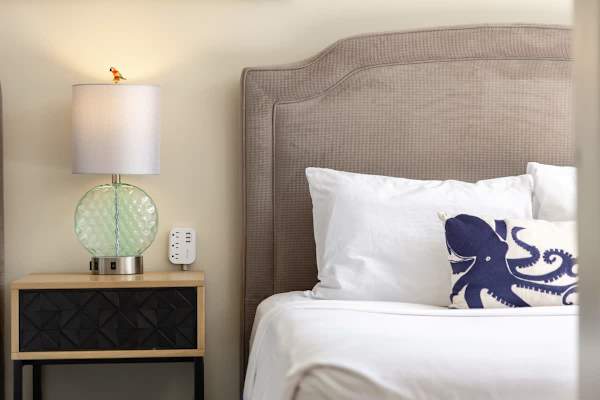 Sink into the cozy bed, and enjoy the chic lamp and smart charging station just a reach away.