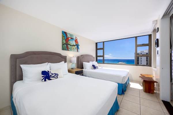 Rest easy and wake up to paradise. Two plush queen beds and stunning ocean views make this bedroom your perfect escape.