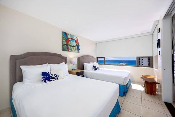 Draw the shade and let the sun and incredible ocean view greet you from the comfort of your two queen beds.