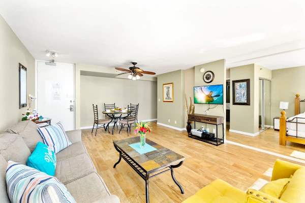 Living room with pull-out sleeper sofa, ceiling fan,  a cable TV, a coffee table, and a chair.