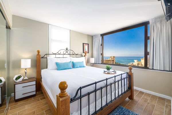 Relax in your bedroom with a king-size bed, 2 nightstands, and a beautiful ocean view.