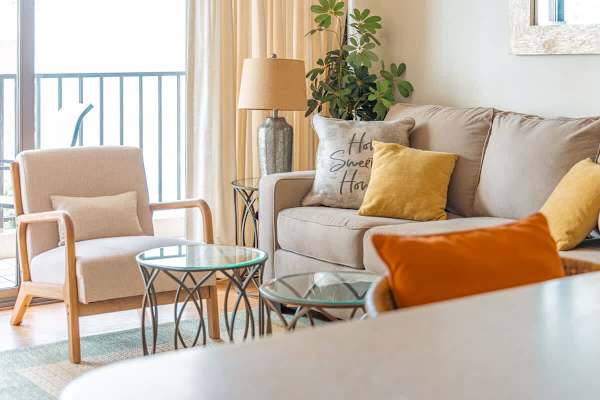 Pull-out sleeper sofa in the living room with coffee table, 2 nightstands, and armchair.
