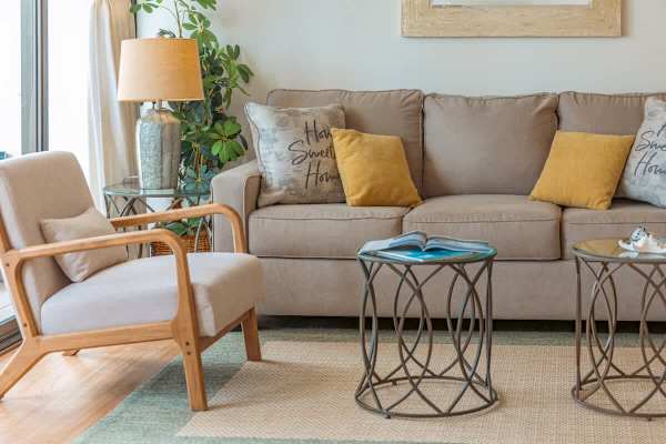 Pull-out sleeper sofa in the living room with coffee table, 2 nightstands, and armchair.