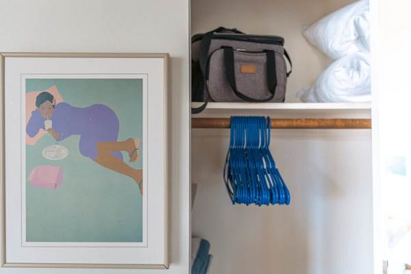 Bedroom cabinet with hangers, and extra pillows