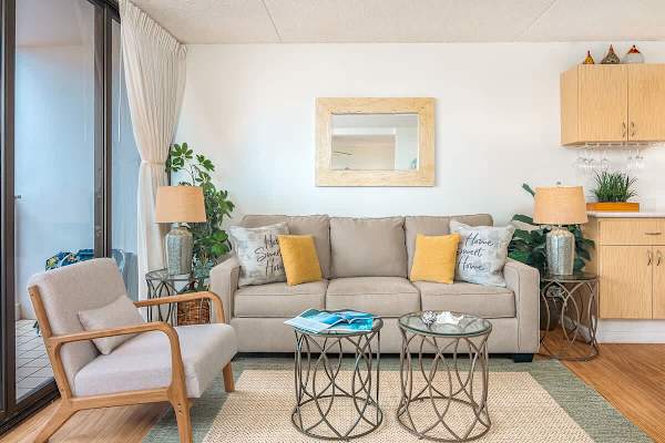 Pull-out sleeper sofa in the living room with coffee table, 2 nightstands, and armchair.