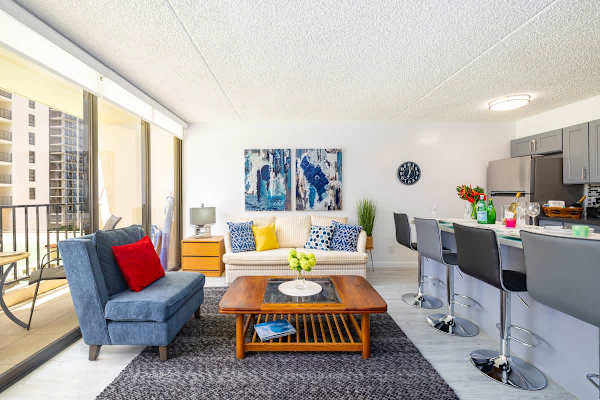 Living room with one armchair, pull-out sofa, and a countertop for dining up to 4 people.