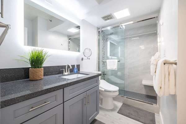 Remodeled bathroom with walk in shower. Bidet on the toilet