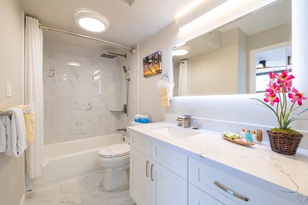Full bathroom with tub and shower combo with vanity and cabinet.
