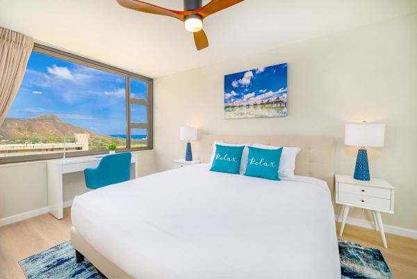 Bedroom with King-size bed, ceiling fan and designate work space desk 