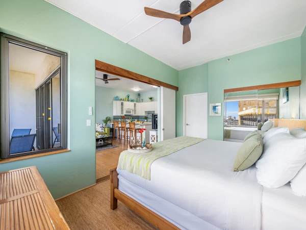 Bedroom with king size bed and ceiling fan. It can be closed off from the living room