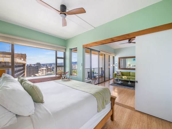 Bedroom with king size bed and ceiling fan. It can be closed off from the living room