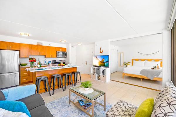 A sliding door separates the living room and has access to the bathroom as well, with a smart TV and standard cable.