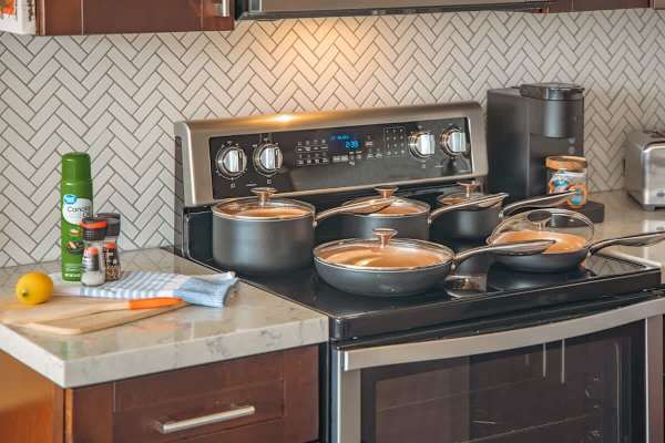 Full-size appliances and kitchen utensils for your culinary needs.