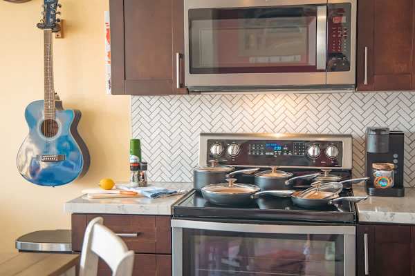 Full-size appliances and kitchen utensils for your culinary needs.