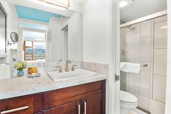 Refreshed in your full bathroom with a walk-in shower, and a vanity with a cabinet.