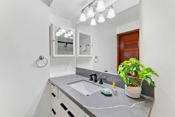Full bathroom with vanity and cabinet