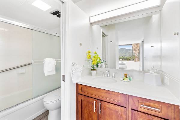 Full bathroom with tub and shower combo and a vanity with cabinet.