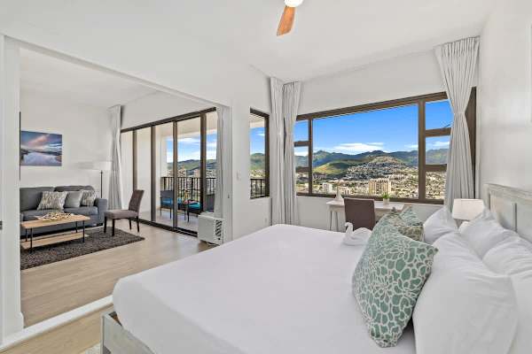 Bedroom with king-size bed and sliding door that separates from the living room.