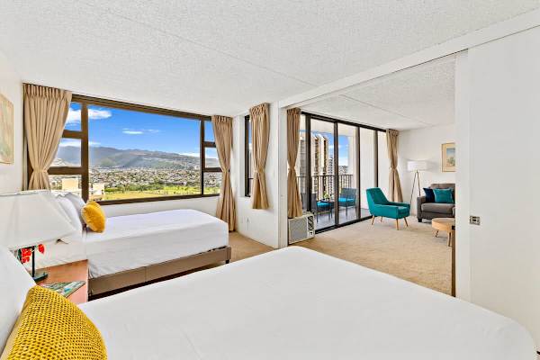 Bedroom with sliding door and mountain views. 