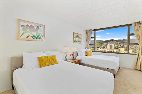 Bedroom with one queen-size and one full-size beds