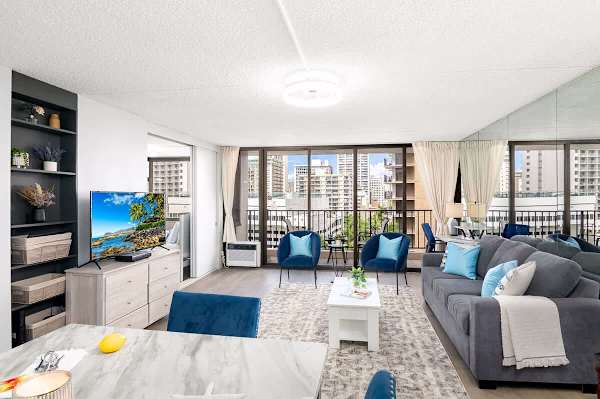 The living room has a pull-out sleeper sofa and a TV.