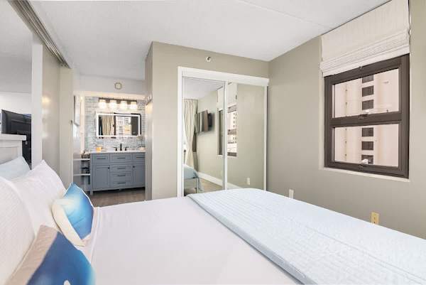 Bedroom with bathroom access and a smart TV