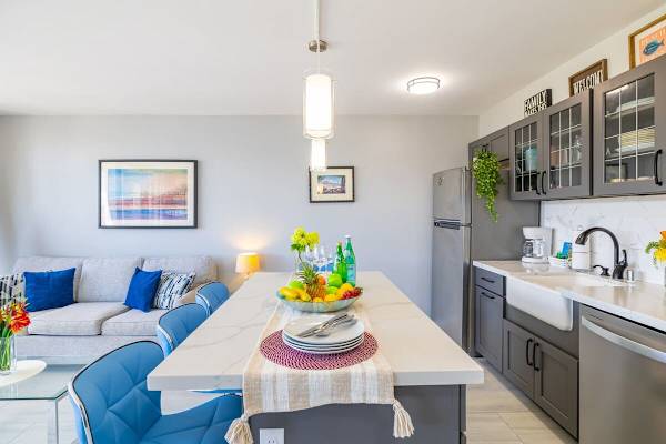 Modern kitchen with a large island and blue seating for casual dining.