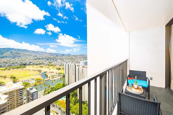 Relax on the balcony with city and mountain views in this modern space.