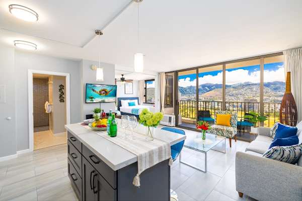 Modern open living space with a balcony offering mountain views