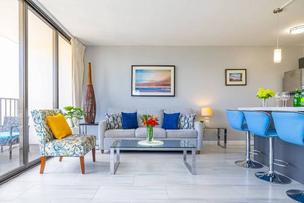 Bright living room with modern seating and a glass coffee table.